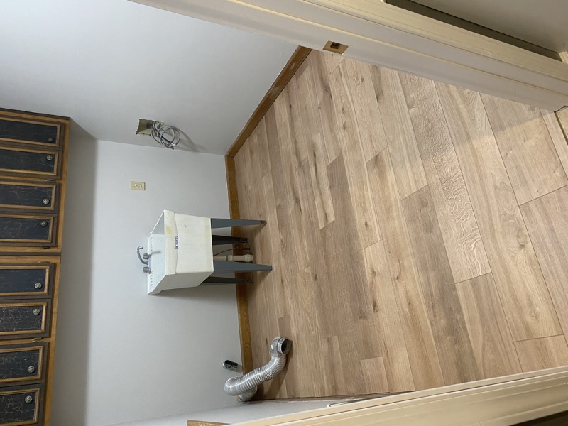 The laundry room finished with new wood-look plank flooring