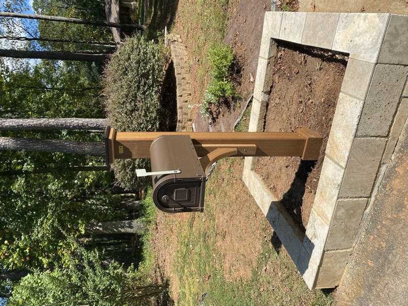 A new mailbox post set in a stone paver surround