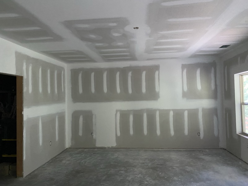 Room with newly hung, taped, and mudded drywall