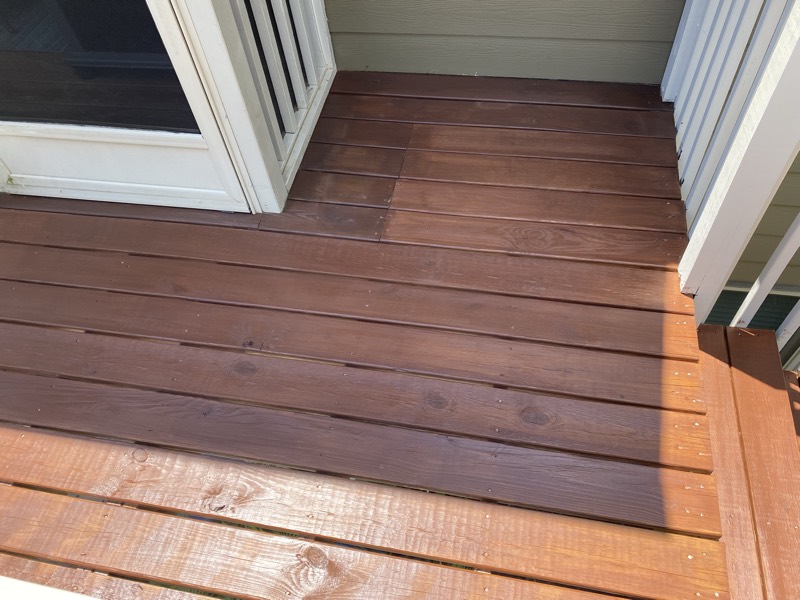 Deck floor boards freshly stained a rich brown