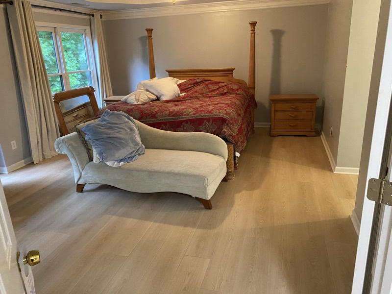 Primary bedroom with new light luxury-vinyl-plank flooring